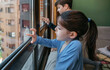 © David Pereiras - Two children in coronavirus lockdown playing draw on the window glass