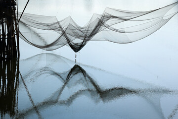 Wall Mural - reflection  of fisherman net  in phattalung thailand