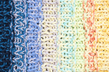 Sweater or scarf fabric texture large knitting. Knitted jersey background with a relief pattern. Wool hand- machine, handmade.