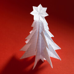 Wall Mural - Christmas trees made of paper on red background. Christmas card