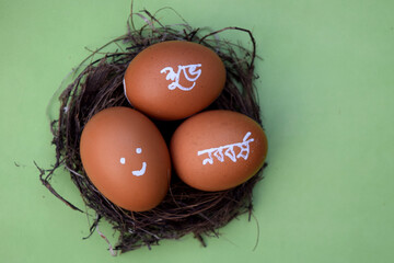 Bengali new year hand typography on the egg. Green isolated background. Bengali translated character.  