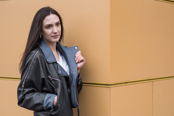 Portrait of a beautiful brunette girl who poses while walking on the street