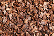 Pine bark for natural weed control in the garden. Brown bark mulch as a background.