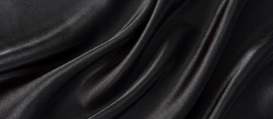 Abstract black silk fabric texture background. Cloth soft wave. Creases of satin