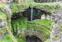 Waterfall Behind A Natural Bridge Covered In Lush Green Vegetation, Baatara Gorge Waterfall, Lebanon