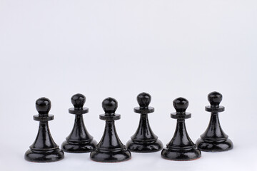 Wall Mural - Black chess pawn figures isolated on white background.