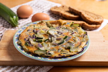 Wall Mural - Zucchini and onion omelette served with bread. Complete vegetarian dish.