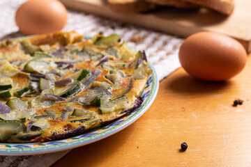 Wall Mural - Zucchini and onion omelette served with bread. Complete vegetarian dish.