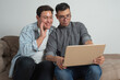 © ChristopherTP - gay couple with laptop, online communication, technology problems