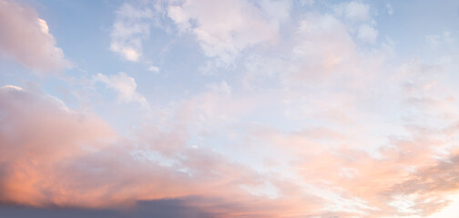 Wall Mural - dreamy romantic background with lighted clouds in pink and blue sky