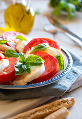 Canvas Print - Caprese salad with mozzarella cheese, tomatoes and basil. Typical Italian cuisine