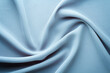 © aninna - light blue fabric draped with swirl folds, textile background