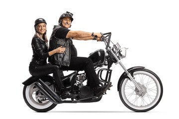 Wall Mural - Full length profile shot of a mature biker and a young woman on a custom chopper