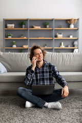 Poster - Male Freelancer With Laptop Talking On Cellphone Sitting At Home