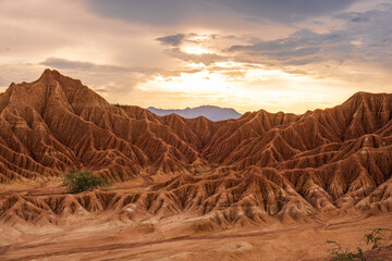 Desert Tatacoa - Desierto de la Tatacoa, Colombia. Amazing dry landcscape strewn with cacti during sunset, dramatic cloudy skies. Dry tropical forest. Parque Nacional Natural Los Nevados, Villavieja