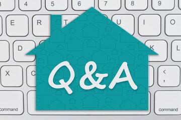 Wall Mural - Questions and Answer message on a house sign on a keyboard