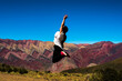 © Javier - Mujer turista saltando de alegría en el cerro de los 14 colores. El Hornocal, Jujuy, Argentina