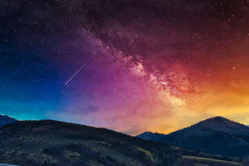 Wall Mural - Milky Way on the vibrant sunset sky over picturesque hills