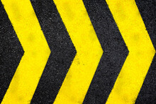 Top View Of Dark Wet Asphalt Road With Three Yellow Arrow Signs. High Resolution Full Frame Textured Background Of Black Asphalt, Viewed From Above.