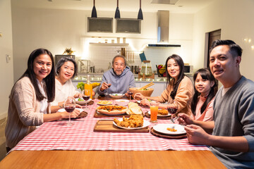 Portrait of Asian big family having dinner party in the kitchen.