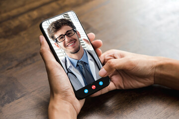 Patient making video call with doctor online via smartphone, home medical consulation service and telehealth concepts