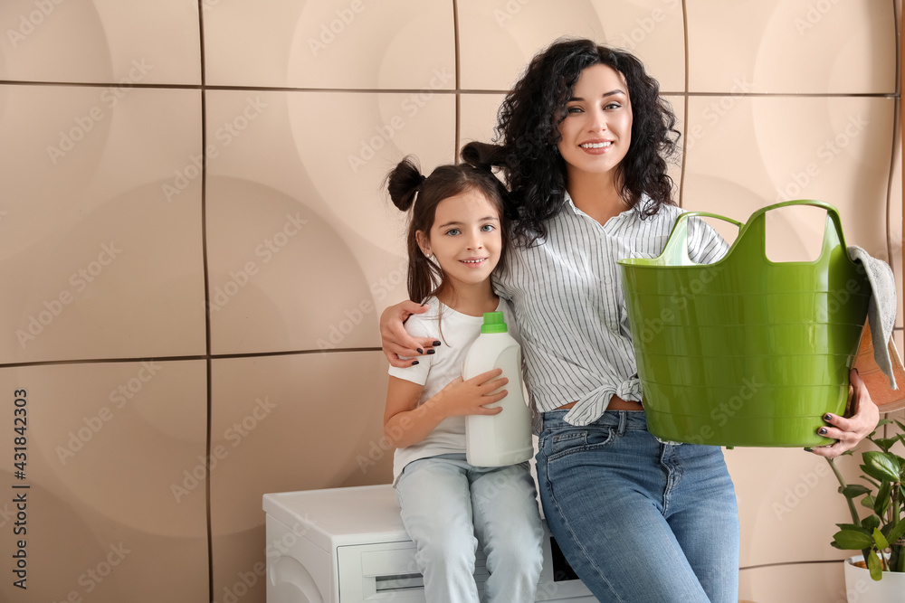Mother and daughter doing laundry at home