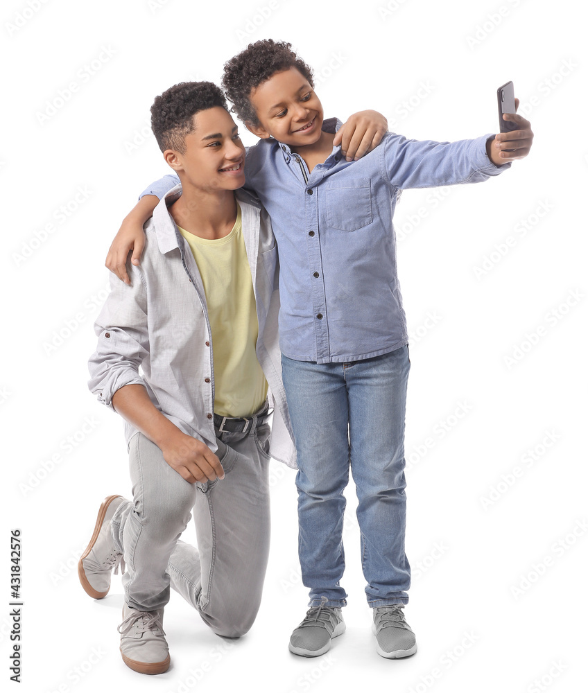 African-American boys taking selfie on white background