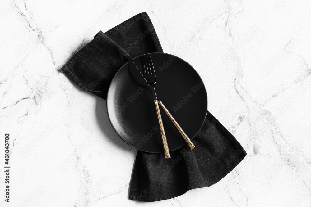 Plate, cutlery and stylish napkin on light background