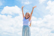 © be free - happy child in summer dress on sky background, carefree