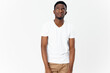 © SHOTPRIME STUDIO - happy african man in white t-shirt and beige pants on light background