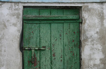 Old Door With Peeling Green Paint And A Metal Lock