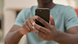 © stockbakers - Close Up of African Man Using Smartphone