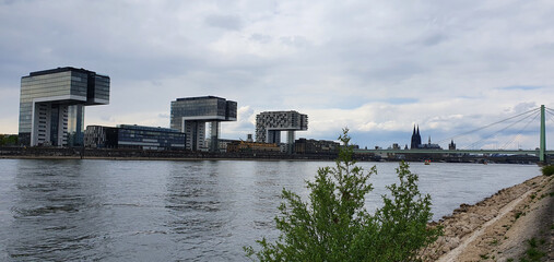 Cologne Germany May 2021 beautiful view of the Rhine, the crane houses, the Poller Wiesen and skyline with Cologne Cathedral and Groß St. Martin     