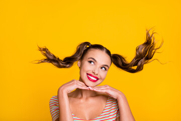 Sticker - Portrait of attractive glamorous dreamy cheerful girl thinking hair flying isolated on bright yellow color background