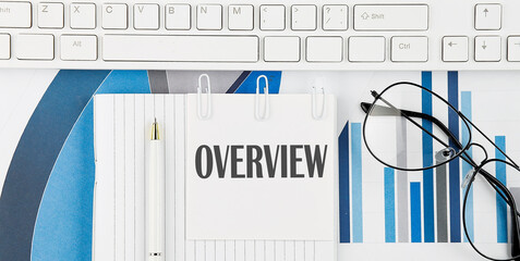 Poster - Office desk table with keyboard, chart,glasses and pen. Top view with text OVERVIEW