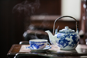 Wall Mural - Old style Chinese tea mugs, Chinese hot tea set on an old Chinese wooden table.