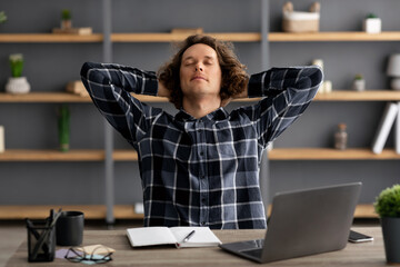 Poster - Guy At Laptop Resting Holding Hands Behind Head At Workplace