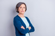 © deagreez - Photo portrait of serious senior woman with crossed hands isolated on grey color background copyspace