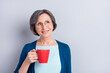 © deagreez - Photo portrait of elder business woman drinking coffee dreamy curious isolated on grey color background