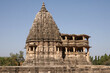 Beautiful shot of one of the monuments of Khajuraho against the clear blue sky in summer