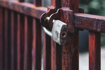 Old padlock locked old iron fence ,many rusty ,