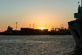 Fototapeta  - Sunset behind containers on a loading dock at the port.