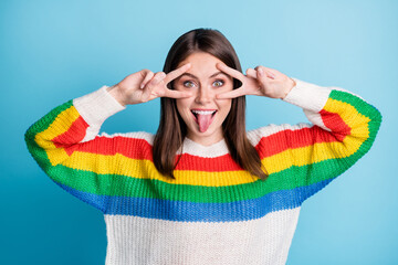 Sticker - Photo of charming funny young lady wear striped outfit showing v-signs cover eye tongue isolated blue color background