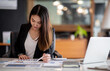 © David - Young Business woman using calculator and laptop for do math finance on wooden desk, tax, accounting, statistics and analytical research concept