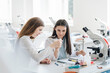 © Hernandez and Sorokina/Westend61 - Young female researchers in white coats examining laboratory sample in science class