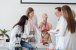 © Hernandez and Sorokina/Westend61 - Professor with students analyzing anatomy model in class
