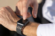 © Boy/Westend61 - Close-up of businessman using smart watch outdoors
