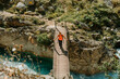 © David Molina Grande/Westend61 - Woman walking on bridge while exploring Cares Trail in Picos De Europe National Park, Asturias, Spain