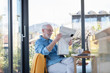 © Emma Innocenti/Westend61 - Man reading newspaper while sitting at home