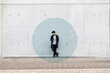 © Emma Innocenti/Westend61 - Visualization of data coming out of smart phone used by young manÔøΩstanding outdoors